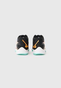 Black athletic shoes with a textured upper, orange accents, and a white midsole. The outsole features a turquoise tread pattern.