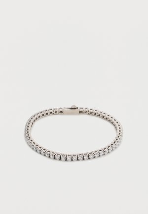 Ασημένιο βραχιόλι τένις με κούμπωμα, διαθέτει μία σειρά από μικρές στρογγυλές διάφανες πέτρες.