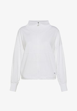 Valkoinen vetoketjullinen paita, jossa korkea kaulus, lörpötetyt olkapäät ja resorit hihansuuissa. Helmassa on hienovarainen logotyyppinen yksityiskohta. Pehmeä tekstuuri.