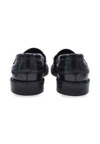 Black leather loafers with a smooth finish, rounded toe, and stitched detailing. Features a low profile and sturdy black rubber sole.