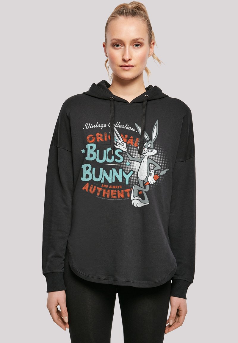 Čierna mikina s uvoľneným strihom, s vintage grafikou Bugs Bunny v tyrkysovej a červenej farbe. Detail s šnúrkami pri kapucni a rebrované manžety.