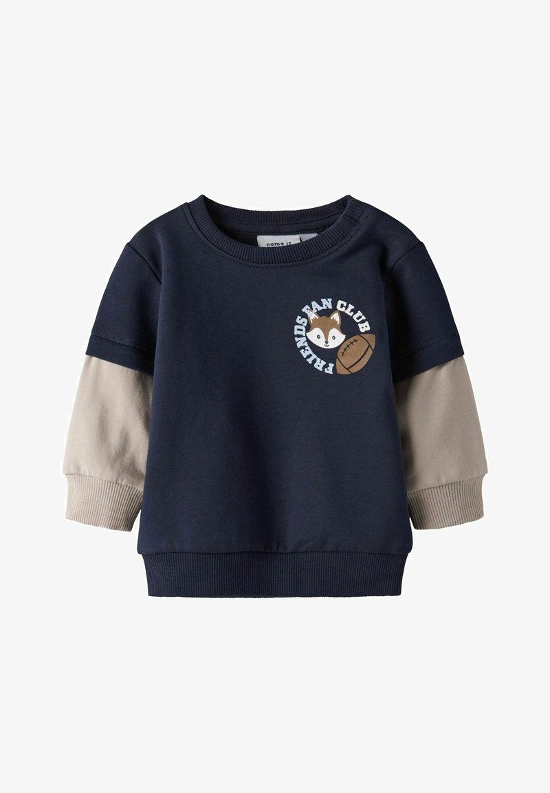 Sweatshirt bleu marine avec des manches beiges, des poignets et un ourlet côtelés. Présente un renard en personnage de dessin animé et le texte "Club des Amis" sur le devant. En coton.