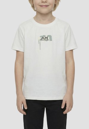 Dijete u bijeloj kratkourukoj majici s malim apstraktnim uzorkom i tekstom "Antony Morato" na prsima, u kombinaciji s crnim hlačama.