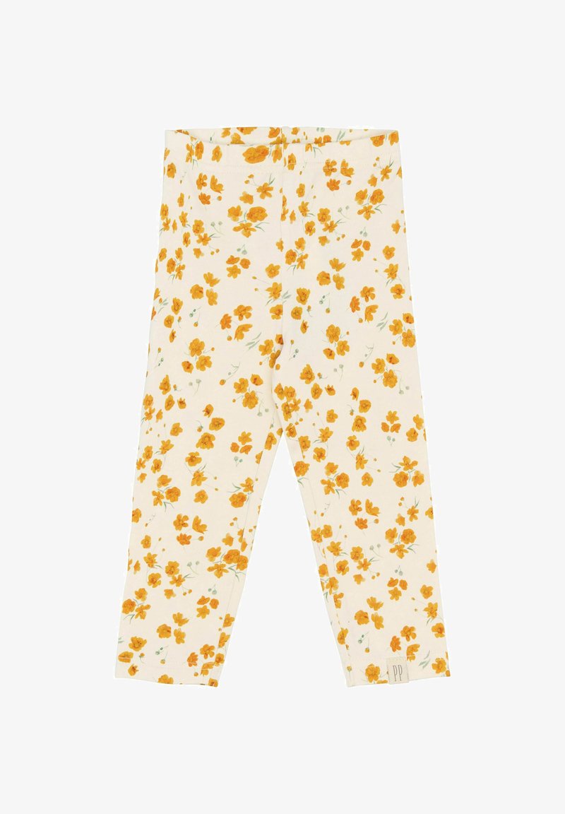 Leggings fleuris en tissu couleur crème présentant un motif éparpillé de fleurs jaunes et de tiges vertes ; matériau doux et extensible.
