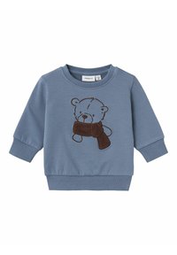 Felpa blu realizzata in morbido cotone, con un orso ricamato marrone che tiene una sciarpa marrone. Dettagli con polsini e bordo a costine.