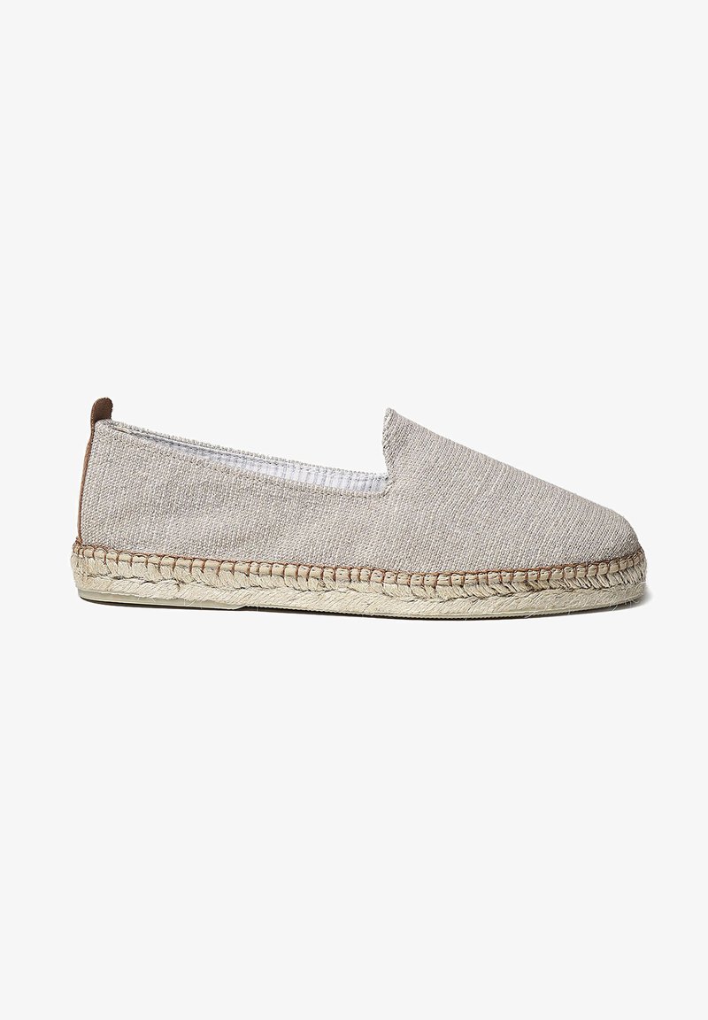 Beige espadrille shoe with a textured fabric upper, elasticized opening, and jute rope sole. Features a brown heel accent.