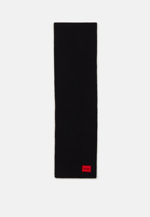 Black knit scarf with a rectangular shape and a red HUGO logo patch at one end. Smooth texture, no patterns or additional accents.