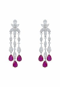 White gold chandelier earrings with clear diamonds and three dangling pear-shaped red gemstones on each earring.