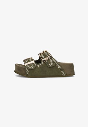 Sandalo slip in suede verde oliva con due fibbie dorate e cuciture bianche a zig zag su una suola spessa, vista laterale su sfondo bianco.