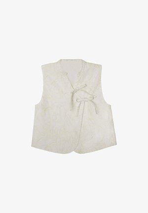 Gilet sans manches à motifs floraux en tissu crème clair, présentant un design enveloppant avec une fermeture à nouer et de subtils accents texturés.
