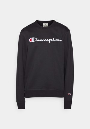 Melna sporta jaka, izgatavota no kokvilnas maisījuma, ar baltu "Champion" logotipu un sarkanu akcentu. Ribotas piedurknes un apakšmala. Klasiska, brīva piegriezuma.