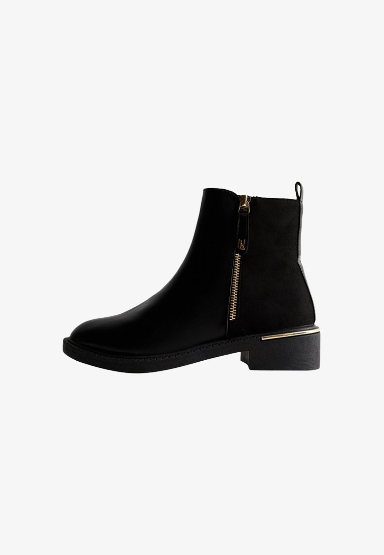Bottes noires à la cheville avec une finition en cuir lisse, détail en zipper doré, petit talon carré et semelle texturée pour une meilleure adhérence.