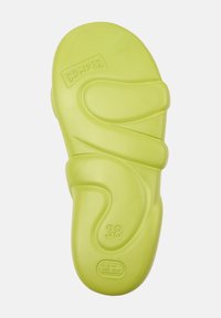 Green plastic sandal sole, size 38. Features fluid, wavy shape and smooth texture with brand logo embossed on surface.