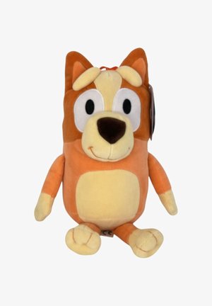 Pluche hond speelgoed met een oranje en gele kleurenschema, grote ogen, zachte oren, ronde lichaam en zachte textuur. Label zichtbaar aan de zijkant.