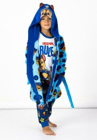Blue fleece robe with cartoon dog pattern, hood with ears, paired with a white graphic t-shirt and patterned pajama pants in blue tones.