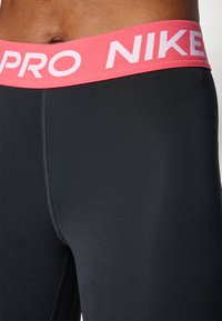 Nike Performance CROP - Leggings - black/aster pink/white