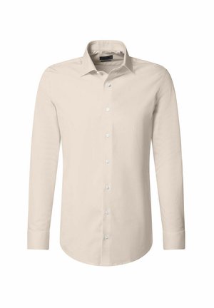 Chemise à manches longues en beige clair, fabriquée en tissu lisse. Elle présente un col pointu, une fermeture à boutons sur le devant et des poignets avec des fermetures à bouton.