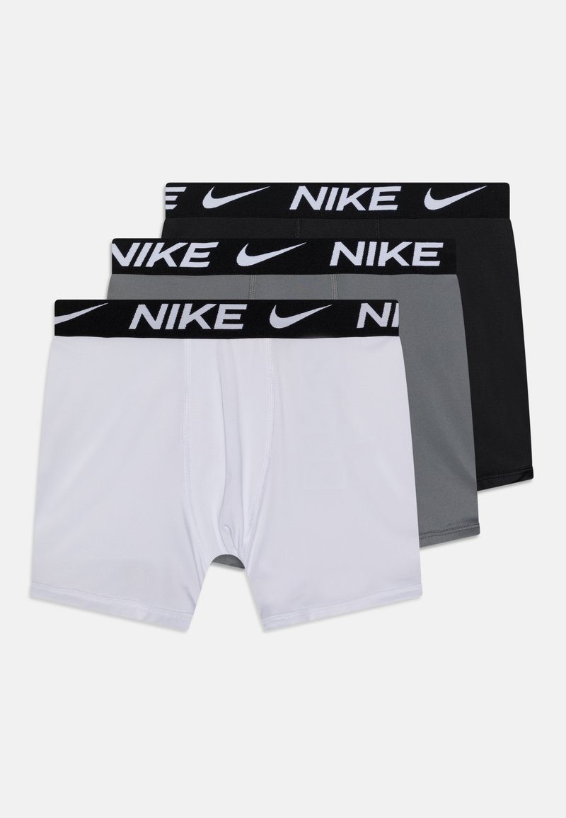 Kolm paari Nike bokserite aluspesu valges, hallis ja mustas värvitoonis. Igal paaril on must elastne vöö, millel on valge Nike bränd ja logo.