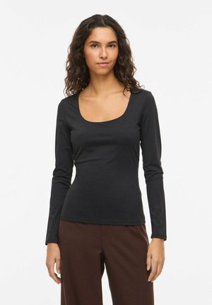 Haut noir à manches longues avec un col carré, fabriqué en tissu lisse et ajusté. Le design comprend des manches fines et une coupe cintrée.