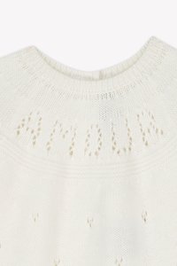 White knitted sweater featuring a ribbed neckline, eyelet patterns, and the word "AMOUR" highlighted in open knit on the back.