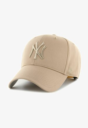 Beige baseball cap made of fabric, featuring an embroidered light-colored "NY" logo on the front and a small "47" logo on the side.