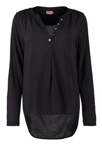 Blusa nera a maniche lunghe con scollo a V, apertura con bottoni e tessuto morbido. Il retro è più lungo del davanti, con un orlo curvo.