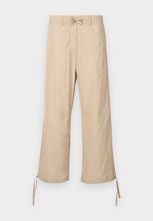 Pantaloni beige a gamba larga con cintura elastica e lacci, caratterizzati da un motivo sottile e legature regolabili all'orlo.