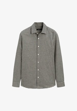 Zwart-wit geruit overhemd met knopen, lange mouwen, kraag en witte knopen. Zacht materiaal, rechte zoom en normale pasvorm.