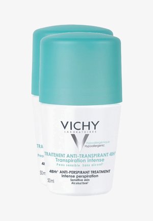 Two cylindrical white containers with turquoise caps, labeled "Vichy," for alcohol-free anti-perspirant, 50ml each, smooth texture.