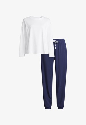 Chemise blanche à manches longues associée à un pantalon de jogging bleu marine à cordon, conçu pour un confort décontracté ou détente.