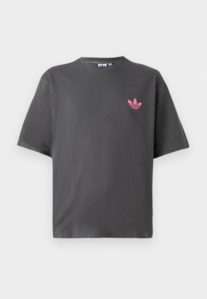 Dark gray short-sleeve T-shirt with a small pink Adidas trefoil logo on the left chest, displayed against a white background.