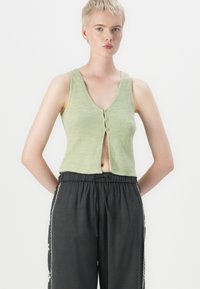 Light green cropped tank top with a V-neck and three front buttons, paired with dark gray elastic waist pants featuring white trim details.