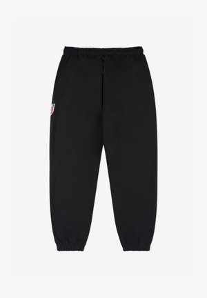 Czarne spodnie dresowe z elastycznym pasem i mankietami. Posiadają małą, kolorową naszywkę z logo na lewej udzie. Wykonane z miękkiego, teksturowanego materiału.