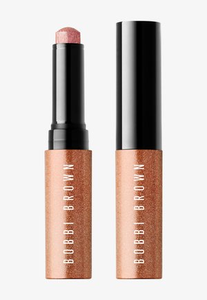 Stick de maquillage Bobbi Brown en or rose brillant avec un capuchon noir, un fermé et un ouvert montrant la pointe arrondie du produit.