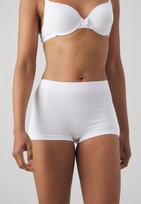 Bijele rebraste pamučne gaćice boyshorts s mekim pojasom, s glatkom teksturom i čvrstim prijanjanjem, dizajnirane za udobnost.