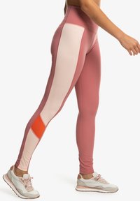 Pink and light pink leggings with an orange accent, featuring a high waist and form-fitting design, made from stretchy athletic material.
