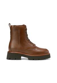 Bottes en cuir marron à lacets, à la cheville, avec un bout rond, une semelle en caoutchouc et un accent surpiqué le long du bord. Dotées d'une languette à l'arrière du talon.