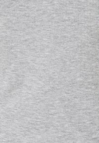 Light gray ribbed fabric featuring a subtle texture with vertical lines, creating a soft, cushioned appearance.