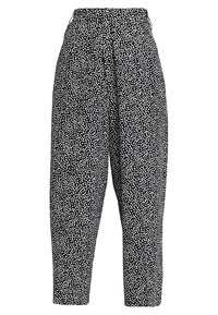 Svart och vitmönstrade byxor med hög midja, avsmalnande ben och en avslappnad passform, med en prickig textur genom hela plagget.