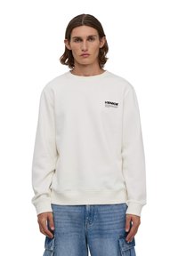 Biała bluza z okrągłym dekoltem, wykonana z bawełny, z małym nadrukiem "VENICE" w czerni na klatce piersiowej oraz ściągaczami na rękawach i u dołu.