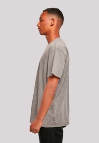 Gray oversized t-shirt made from soft cotton, featuring a relaxed fit, short sleeves, and subtle fading for a vintage look.