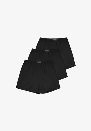 Drei schwarze Boxershorts mit elastischem Bund übereinander gestapelt, jeweils mit einem kleinen rechteckigen Etikett mittig am Bund.
