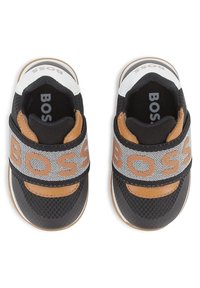 Black mesh sneakers with tan accents, featuring a wide gray strap with "BOSS" in orange. Rounded toe and white rubber sole.