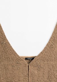 Brown textured fabric top featuring a deep V-neckline, decorative beading, and a scalloped pattern. Tag reads "Massimo Dutti."