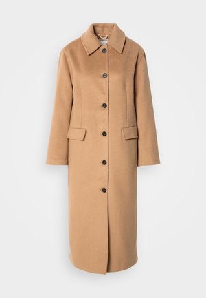 Knielanger Camelcoat aus weicher Wolle mit Kragen, sechs schwarzen Knöpfen und zwei vorderen Taschen.