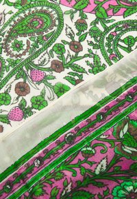 Printed scarf with paisley and floral patterns in green, pink, and brown on a cream background; sheer texture with fine stitching edges.