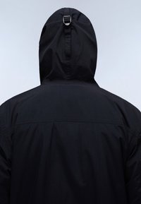 Black hooded jacket, made of soft fabric, features a cinched hood with an adjustable strap and subtle stitching detail on the back.