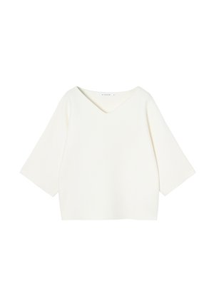 Haut blanc court avec un col en V, manches larges à trois-quarts, fabriqué en tissu doux, présentant une texture lisse et un design minimal.