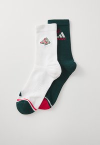 White and dark green crew socks, featuring a floral design on the white pair and striped accents on the green, with ribbed texture.