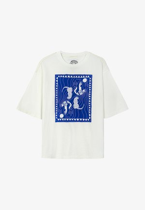 White short-sleeve t-shirt with a blue graphic print featuring stylized figures and dogs, bordered by geometric patterns.